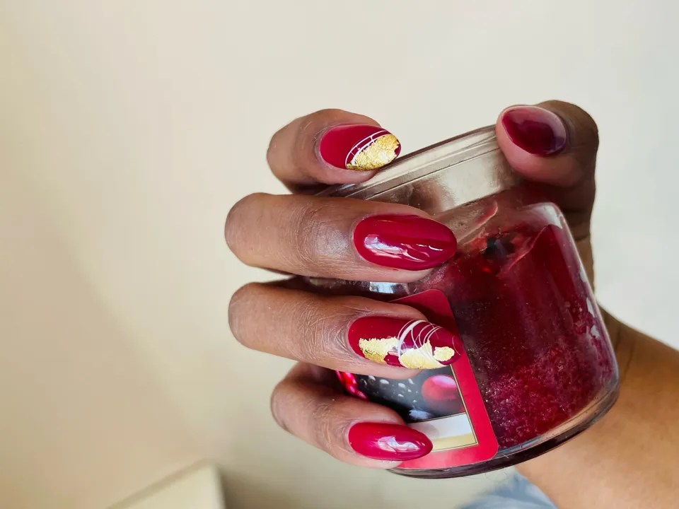 Short, glossy red with a hand-painted accent
